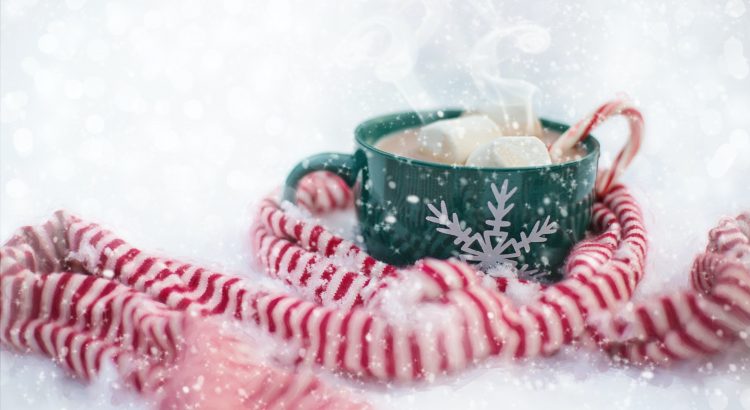 Scarf and a mug of hot chocolate with a candy cane